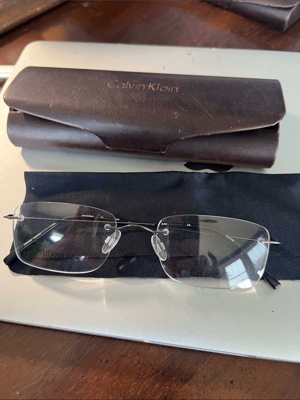 Calvin Klein Rimless Titanium Eyeglasses in Gun metal